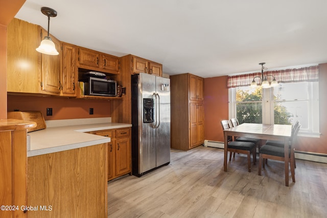 kitchen with a baseboard radiator, appliances with stainless steel finishes, an inviting chandelier, light wood-type flooring, and pendant lighting