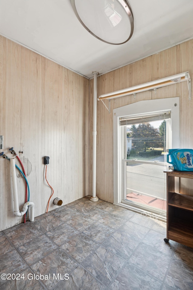 entryway featuring wood walls