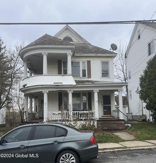 neoclassical home featuring a porch