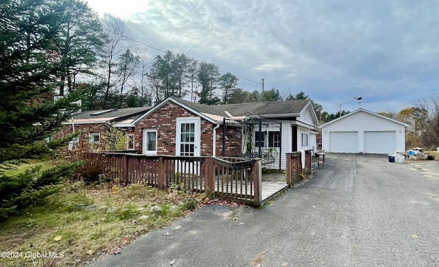 view of front of house featuring a garage and an outdoor structure