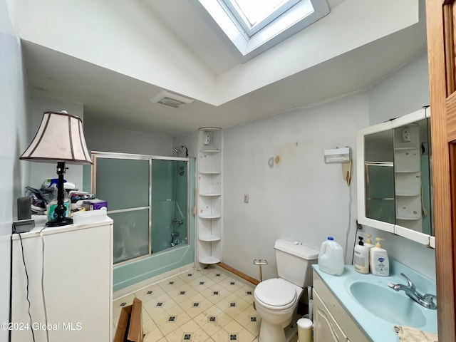 full bathroom featuring toilet, vanity, lofted ceiling with skylight, and shower / bath combination with glass door