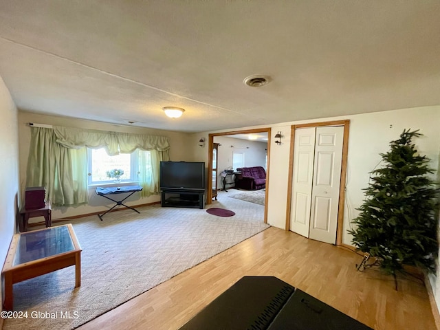 interior space featuring hardwood / wood-style flooring and a textured ceiling