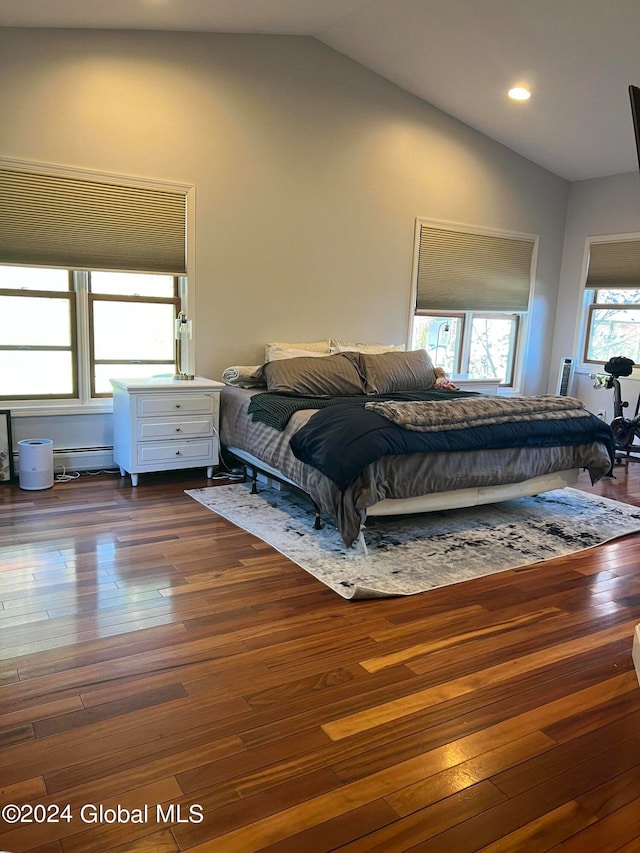 bedroom with dark wood-type flooring and lofted ceiling