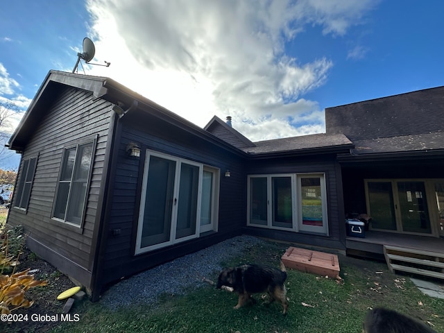 back of property featuring a wooden deck