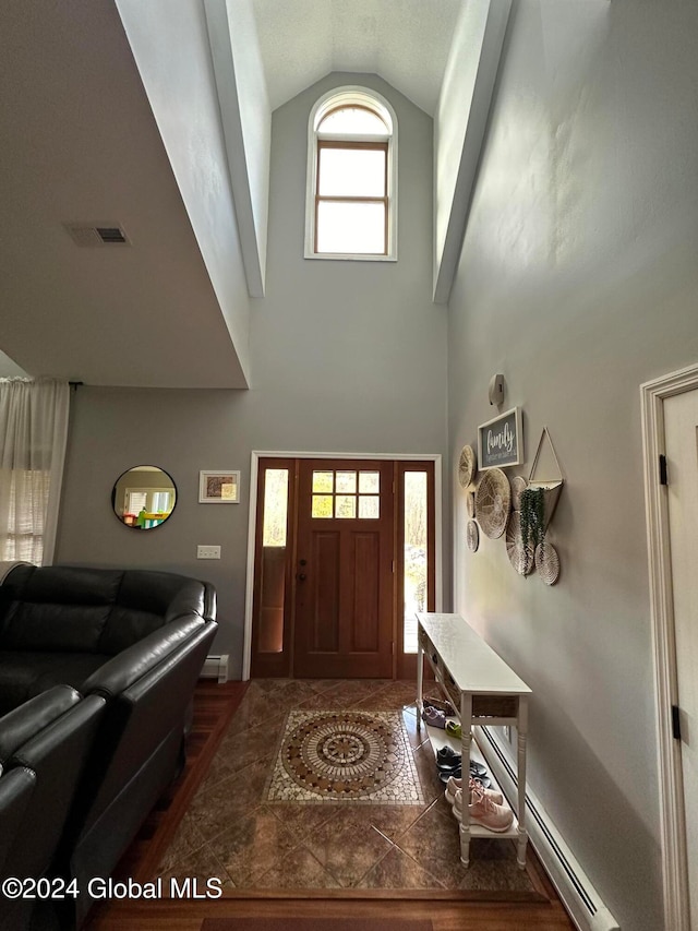 entryway featuring lofted ceiling, a baseboard radiator, and dark hardwood / wood-style flooring