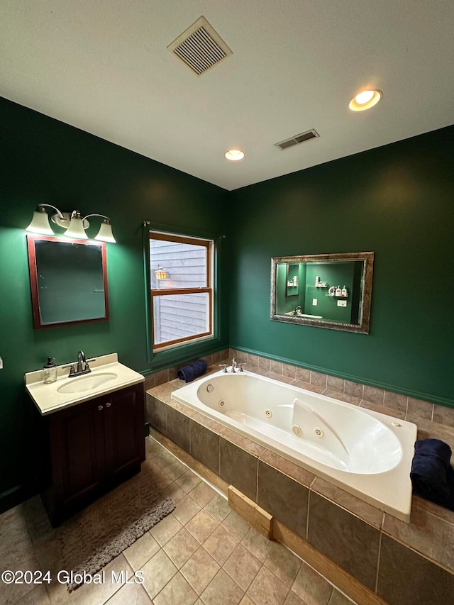 bathroom featuring vanity, tiled bath, and tile patterned floors