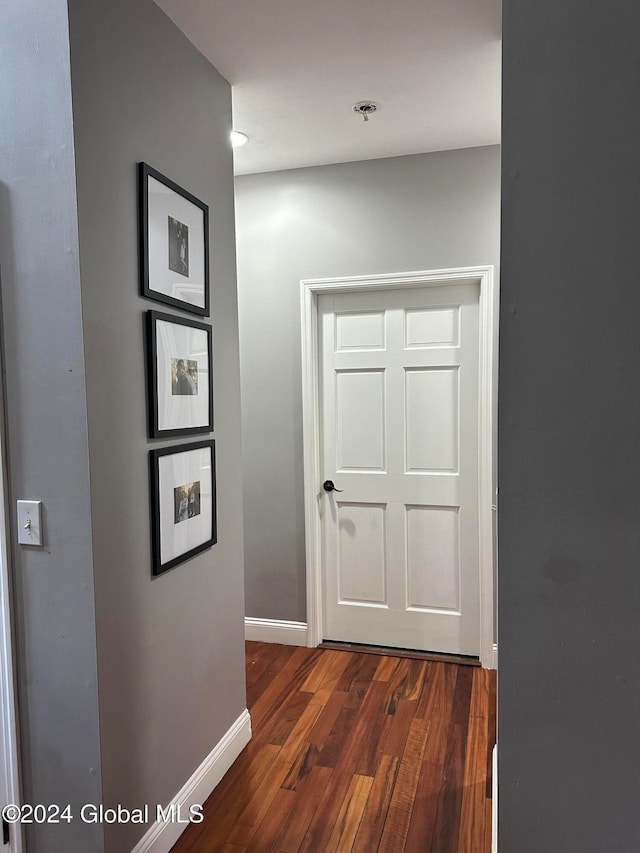 corridor featuring dark hardwood / wood-style flooring