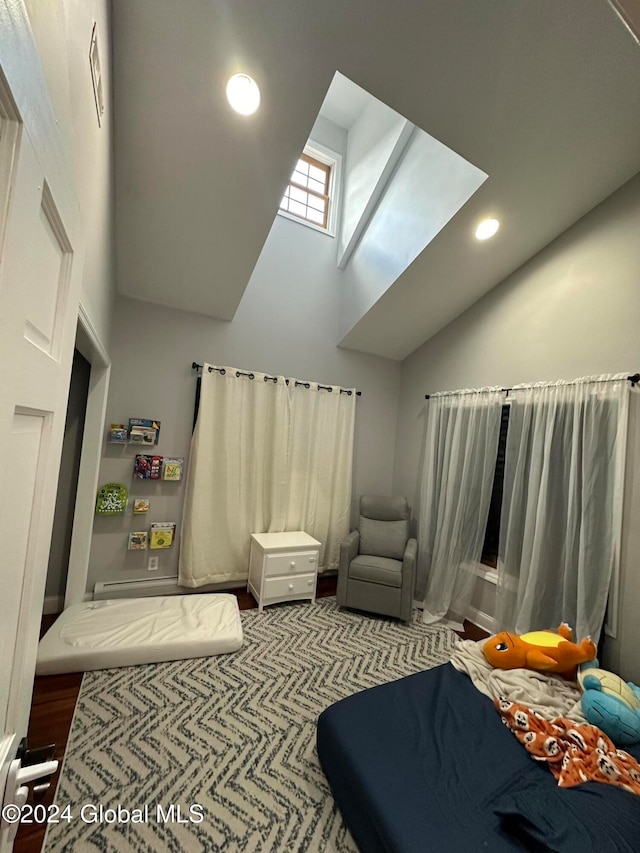 bedroom featuring a high ceiling and a skylight