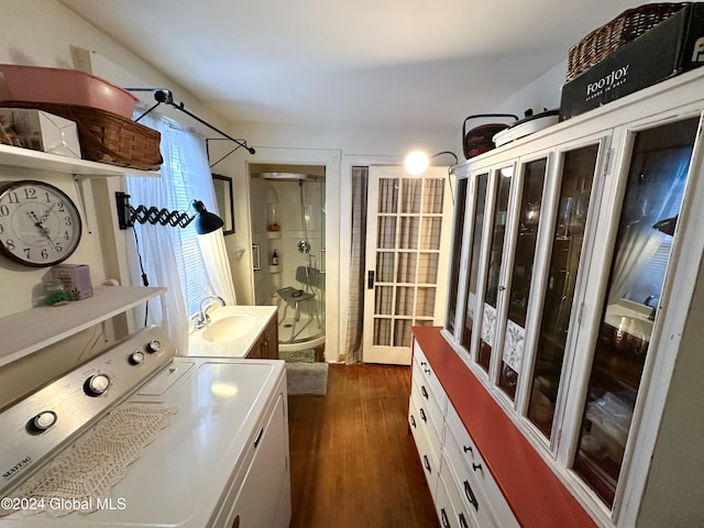 laundry area with sink, dark wood-type flooring, and washer / clothes dryer