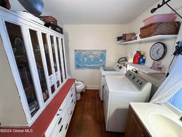 laundry room with washing machine and clothes dryer and dark hardwood / wood-style floors