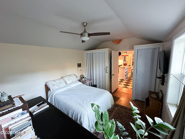 bedroom featuring ceiling fan, lofted ceiling, and hardwood / wood-style floors