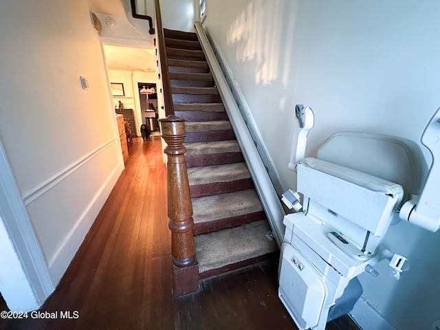 stairs featuring wood-type flooring