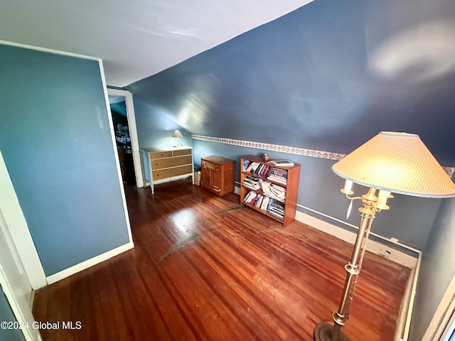 bonus room featuring lofted ceiling and dark hardwood / wood-style floors