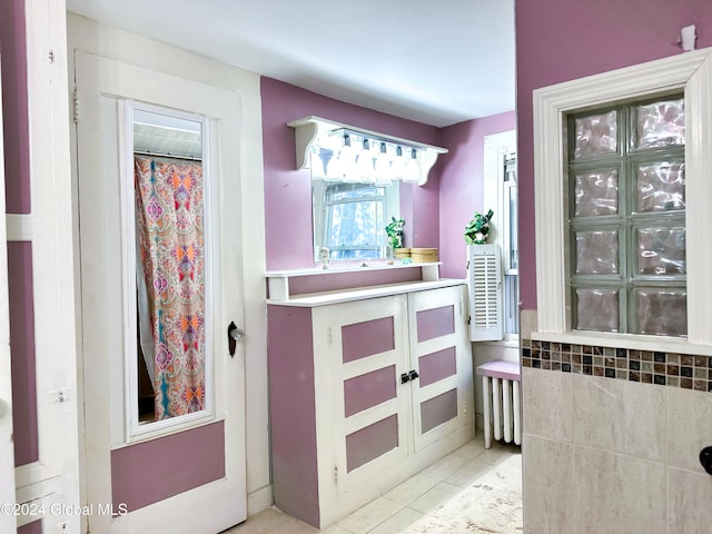 bathroom with walk in shower and tile patterned floors