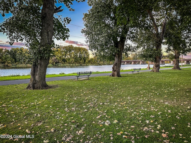 view of home's community featuring a yard and a water view