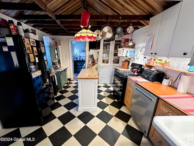 kitchen featuring wooden counters, white cabinetry, decorative light fixtures, and stainless steel appliances