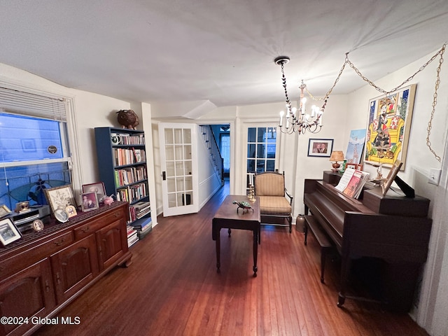 miscellaneous room with an inviting chandelier and dark hardwood / wood-style flooring