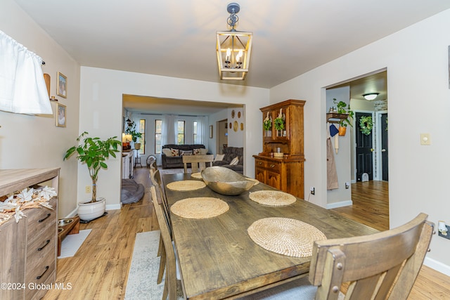 dining room with a chandelier and light wood-type flooring