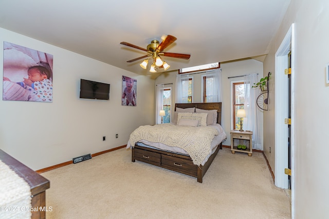 bedroom with light carpet and ceiling fan