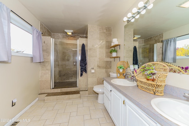 bathroom featuring toilet, walk in shower, vanity, and tile patterned floors