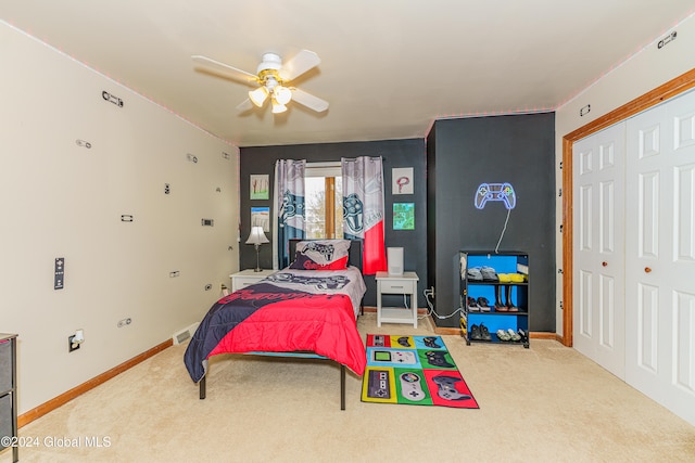 carpeted bedroom featuring a closet and ceiling fan