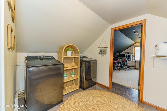 laundry room with washer and clothes dryer and dark colored carpet