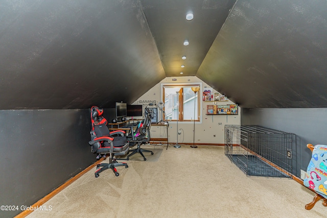 carpeted home office with lofted ceiling