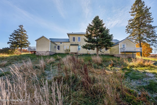 back of house featuring a wooden deck