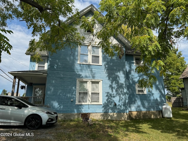 view of side of property with a yard