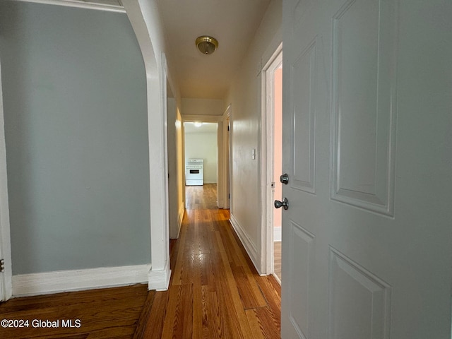 hallway with hardwood / wood-style floors