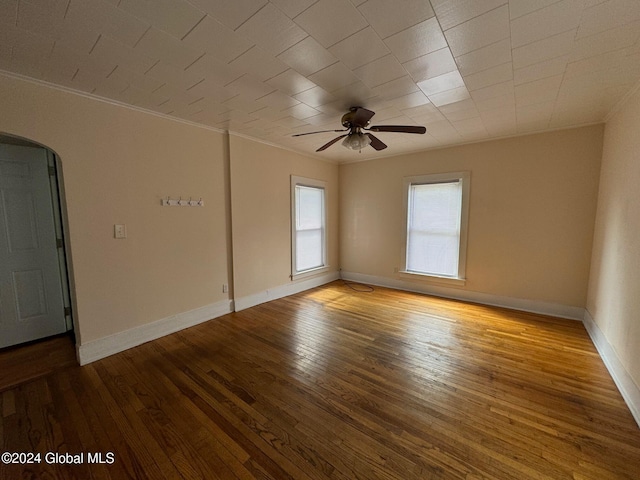 spare room with ceiling fan, crown molding, and light hardwood / wood-style flooring