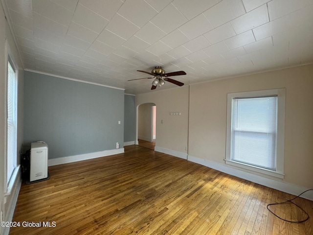 empty room with ornamental molding, hardwood / wood-style flooring, and ceiling fan