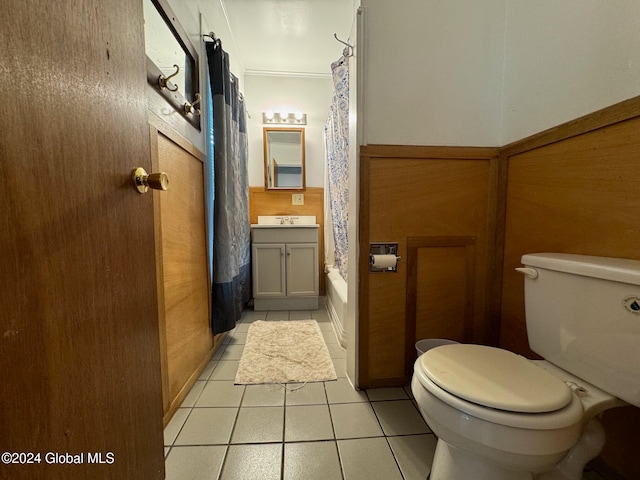 full bathroom featuring toilet, ornamental molding, vanity, shower / tub combo with curtain, and tile patterned flooring