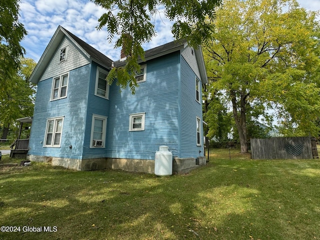 view of side of home with a yard and cooling unit