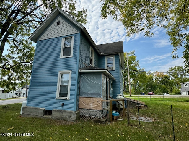 back of property with a lawn