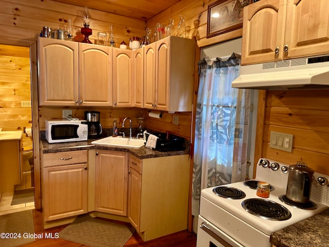 kitchen with wood walls, wooden ceiling, sink, light brown cabinets, and white appliances