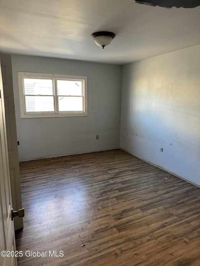 empty room with dark hardwood / wood-style flooring