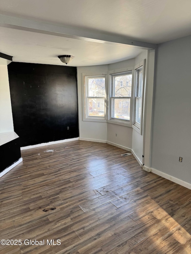 unfurnished room with dark hardwood / wood-style floors