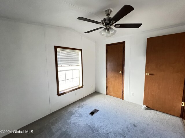 66 Plains Rd, Jackson, NY 12816 - unfurnished bedroom featuring a ceiling fan, visible vents, lofted ceiling, and carpet