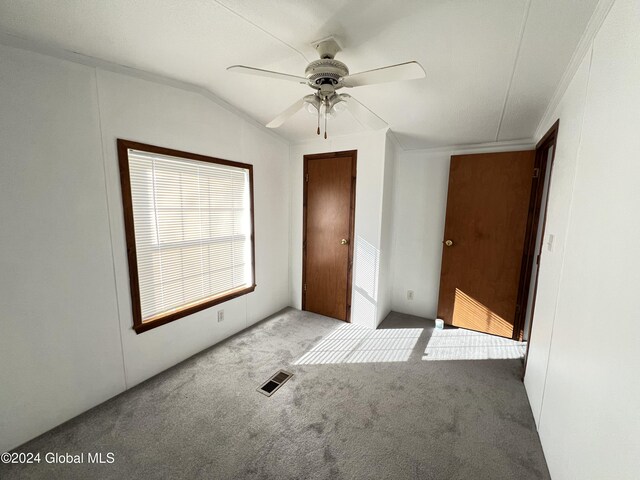 66 Plains Rd, Jackson, NY 12816 - unfurnished bedroom featuring visible vents, crown molding, a ceiling fan, carpet flooring, and vaulted ceiling