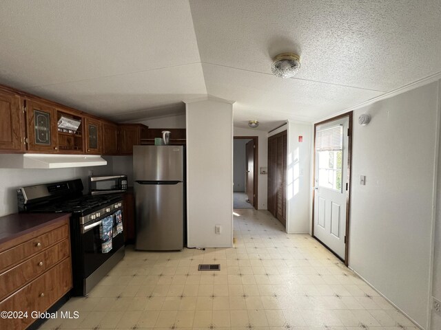 66 Plains Rd, Jackson, NY 12816 - kitchen with dark countertops, glass insert cabinets, light floors, extractor fan, and stainless steel appliances