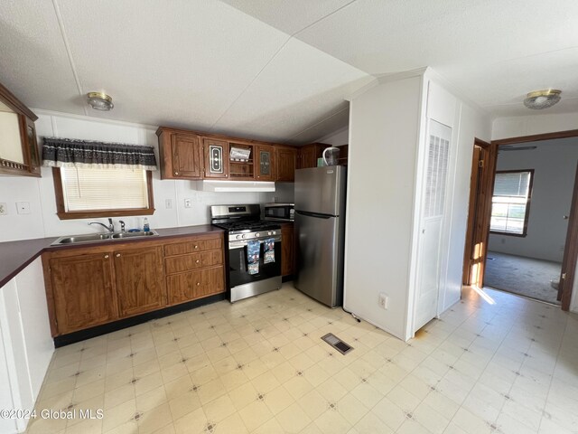 66 Plains Rd, Jackson, NY 12816 - kitchen featuring dark countertops, appliances with stainless steel finishes, a sink, light floors, and under cabinet range hood