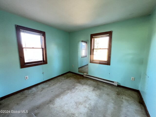 66 Plains Rd, Jackson, NY 12816 - carpeted spare room with baseboards, a healthy amount of sunlight, and baseboard heating