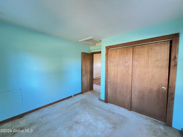 66 Plains Rd, Jackson, NY 12816 - unfurnished bedroom featuring a closet, baseboards, and concrete flooring