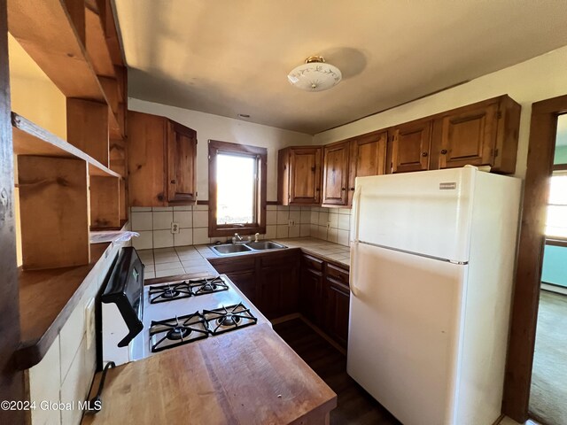 66 Plains Rd, Jackson, NY 12816 - kitchen with tile counters, freestanding refrigerator, a sink, and a wealth of natural light