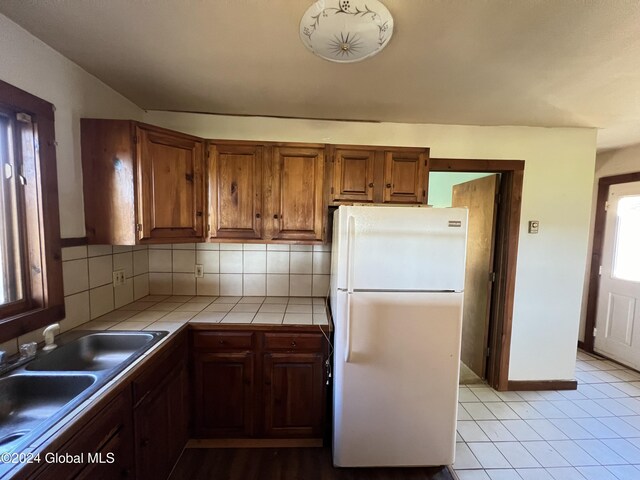 66 Plains Rd, Jackson, NY 12816 - kitchen with tasteful backsplash, brown cabinets, a sink, freestanding refrigerator, and tile counters