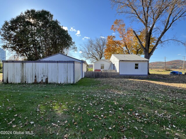 66 Plains Rd, Jackson, NY 12816 - view of yard featuring fence, an outdoor structure, and a pole building