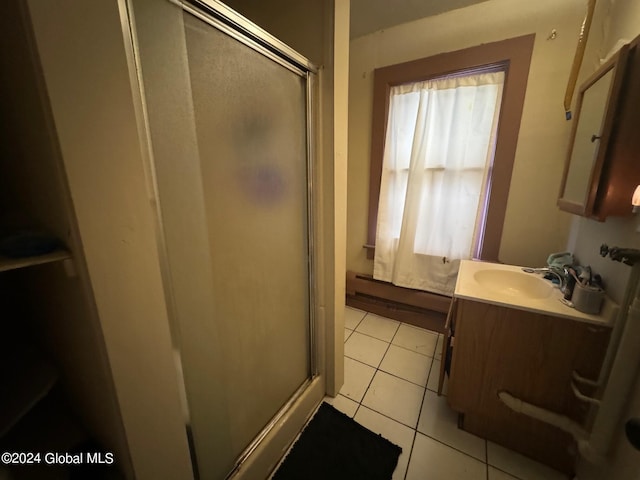 bathroom featuring vanity, tile patterned floors, a shower with shower door, and a baseboard heating unit