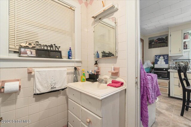 kitchen featuring tile walls and sink