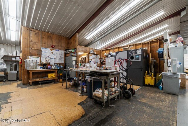 misc room with wooden walls and a workshop area